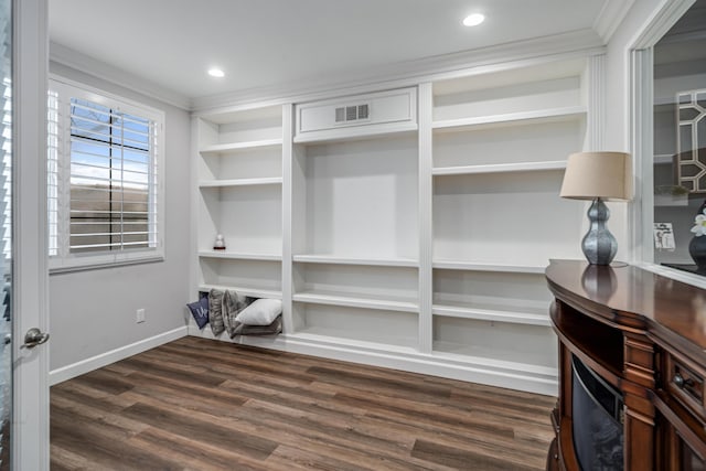 interior space featuring built in shelves, ornamental molding, wood finished floors, recessed lighting, and baseboards