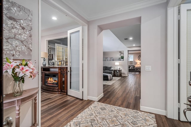 corridor with dark wood finished floors, crown molding, recessed lighting, and baseboards