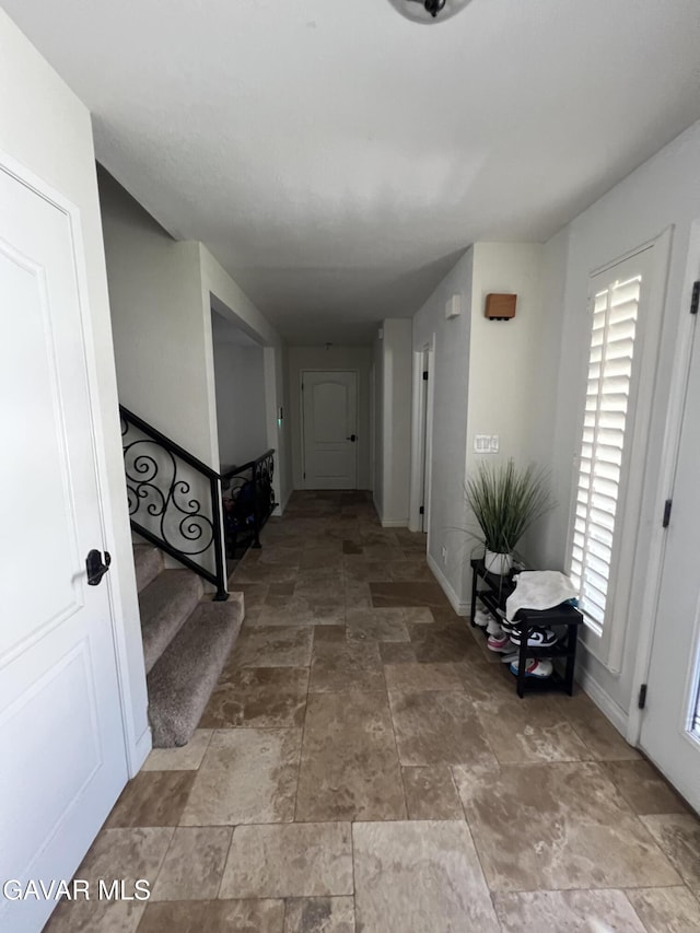 6001 Brougham St, Lancaster, CA 93536 - hallway with light stone finish floors and stairway