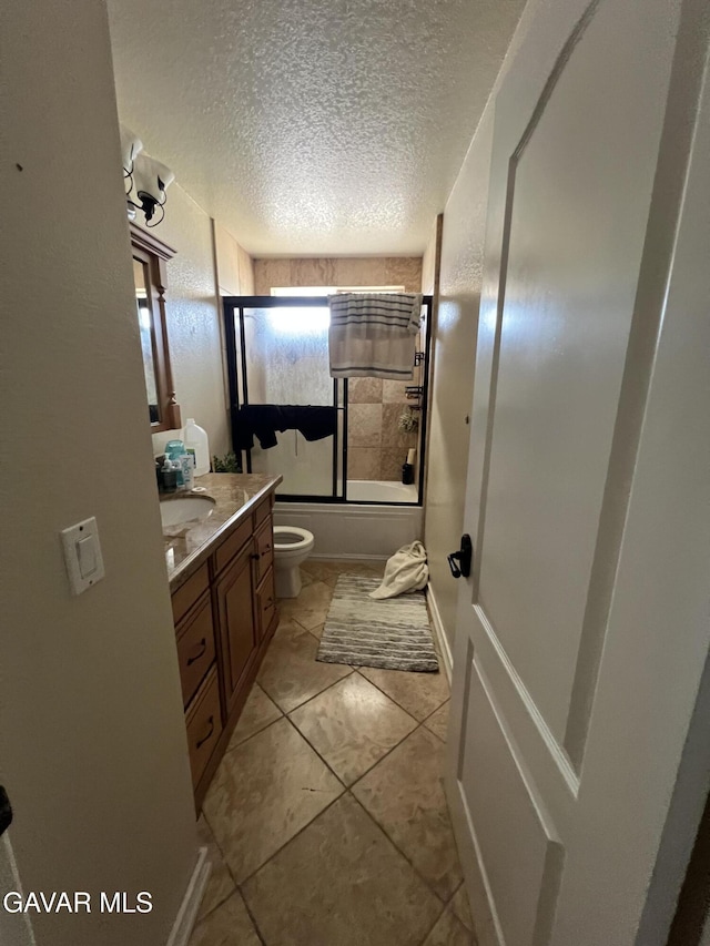 6001 Brougham St, Lancaster, CA 93536 - full bathroom with vanity, combined bath / shower with glass door, a textured ceiling, and tile patterned flooring
