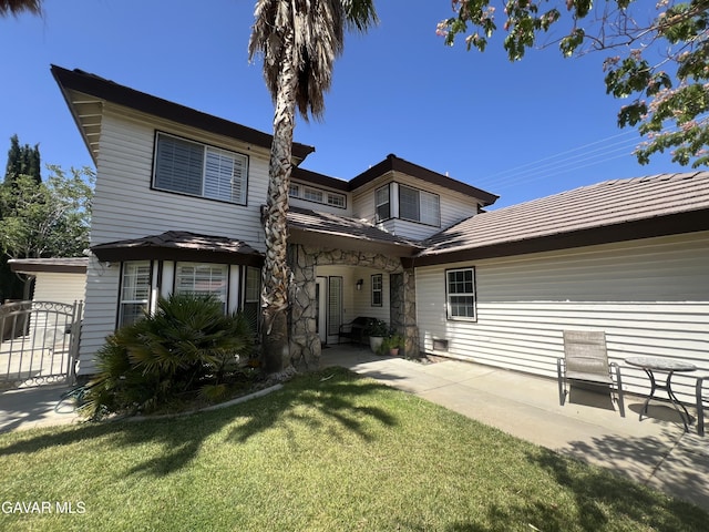 6001 Brougham St, Lancaster, CA 93536 - back of house with a patio area, a lawn, and a gate