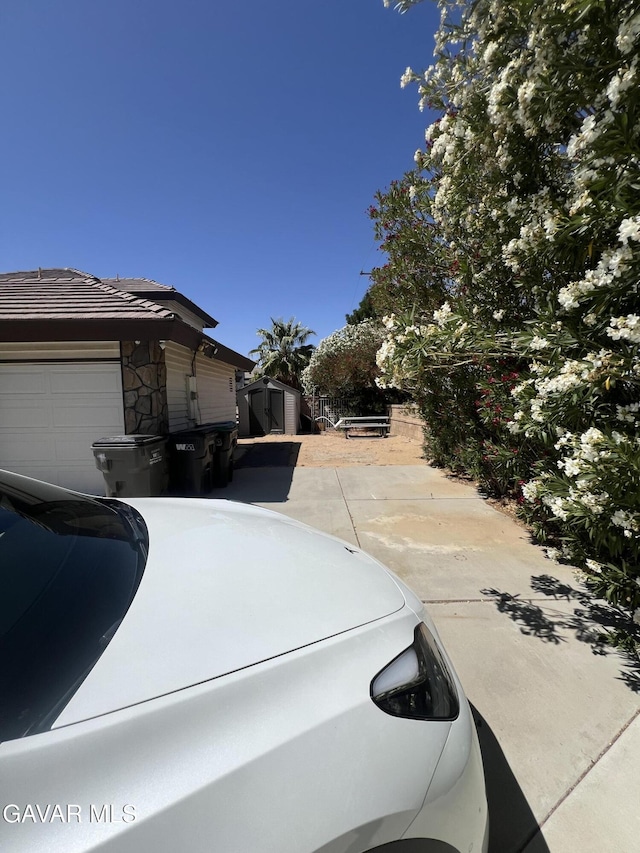 6001 Brougham St, Lancaster, CA 93536 - view of side of property with a shed and an attached garage