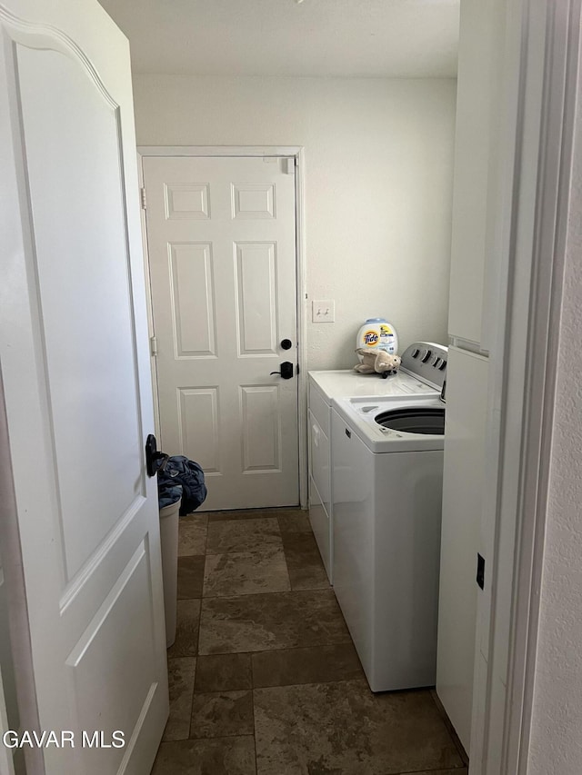 6001 Brougham St, Lancaster, CA 93536 - laundry area with independent washer and dryer and dark stone finish floors