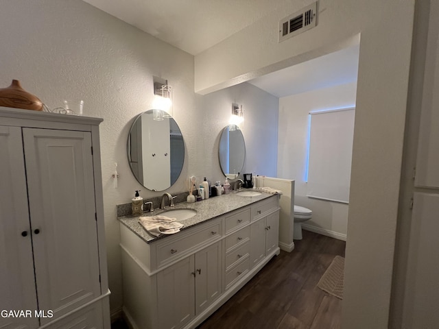 6001 Brougham St, Lancaster, CA 93536 - full bath with double vanity, wood finished floors, and a textured wall