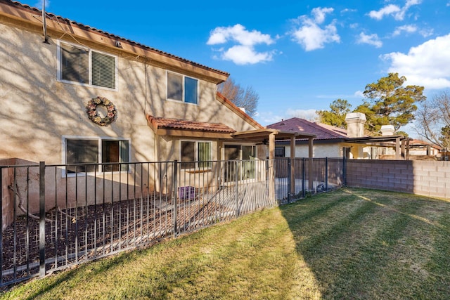 rear view of property featuring a yard