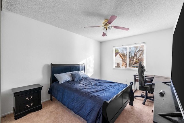 carpeted bedroom with a textured ceiling and ceiling fan