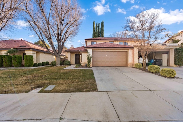 mediterranean / spanish-style home featuring a garage and a front lawn