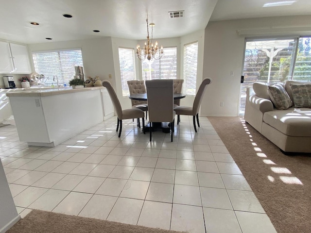 dining room featuring a notable chandelier and light tile patterned floors