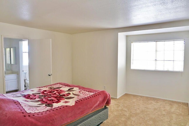 carpeted bedroom featuring connected bathroom