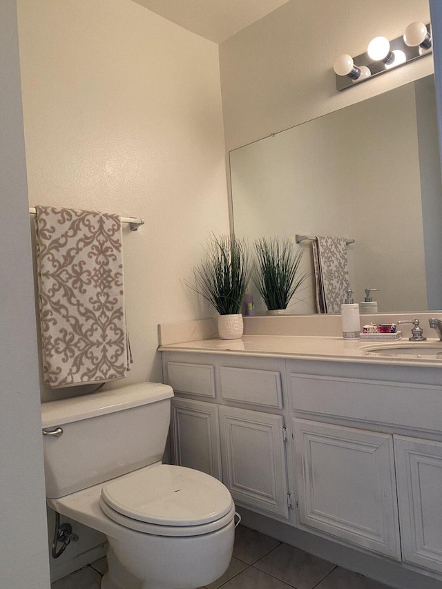 bathroom featuring tile patterned floors, vanity, and toilet