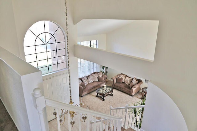 living room featuring carpet and a towering ceiling