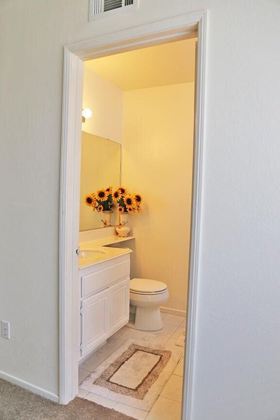 bathroom with tile patterned floors, vanity, and toilet