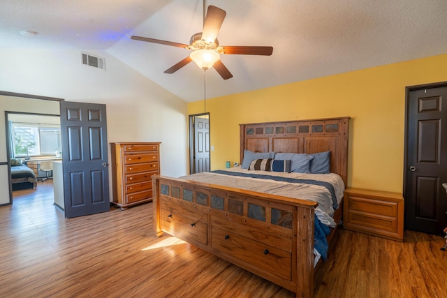 bedroom featuring hardwood / wood-style flooring, vaulted ceiling, and ceiling fan