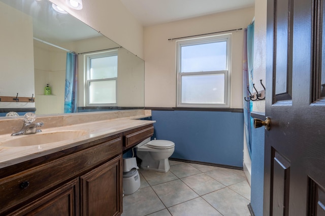 bathroom featuring vanity, tile patterned floors, and toilet