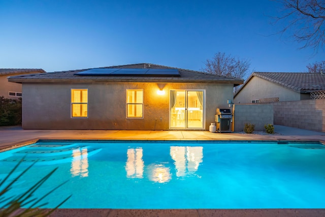 view of pool with a fenced in pool, fence, grilling area, and a patio