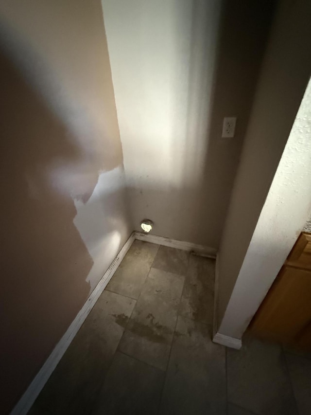 laundry room featuring baseboards