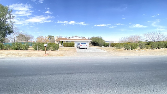 view of front of home with concrete driveway and an attached garage