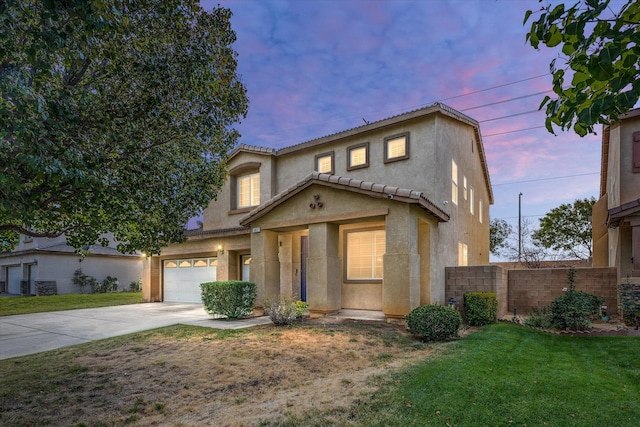 view of front of property featuring a lawn and a garage