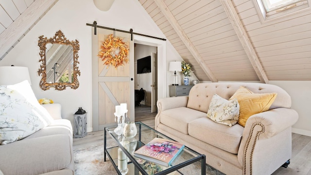 living room featuring vaulted ceiling with skylight, a barn door, wood ceiling, and light hardwood / wood-style flooring