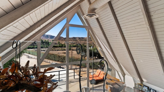 exterior space with a mountain view, vaulted ceiling with beams, and wooden ceiling