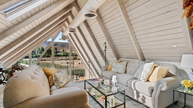 living room with vaulted ceiling with beams, a mountain view, and wood ceiling