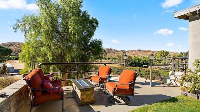 view of patio featuring a mountain view and an outdoor fire pit