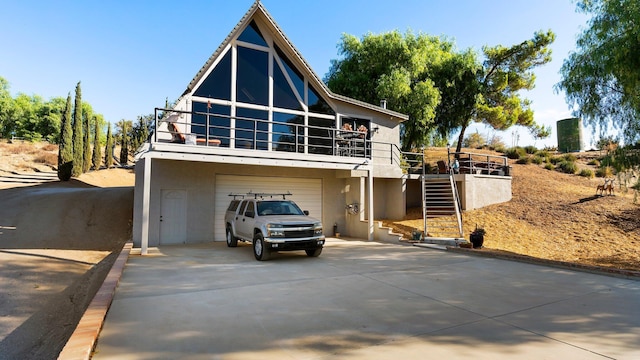 view of front of home with a garage and a balcony