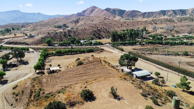 birds eye view of property featuring a mountain view and a rural view