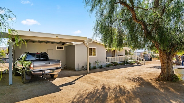 view of side of home with a carport