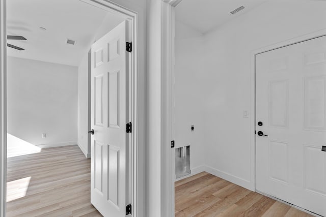 hallway with light hardwood / wood-style flooring