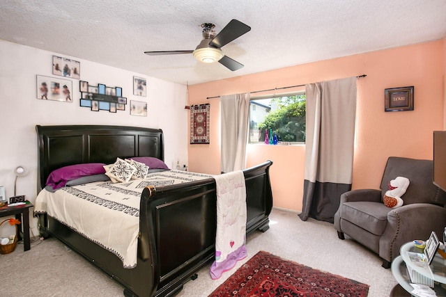 bedroom with light carpet, a textured ceiling, and a ceiling fan