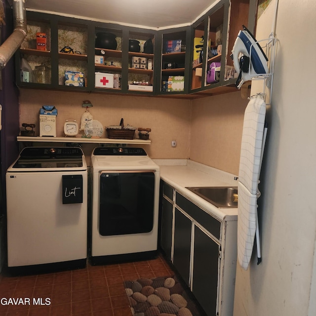 42902 Sachs Dr, Lancaster, CA 93536 - washroom featuring independent washer and dryer, cabinet space, and dark tile patterned flooring