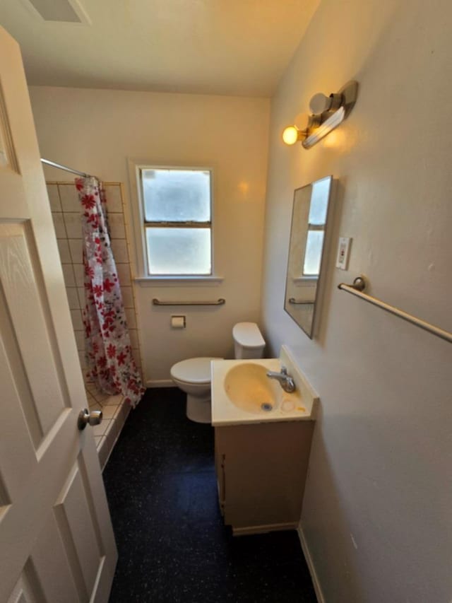 bathroom with curtained shower, vanity, and toilet