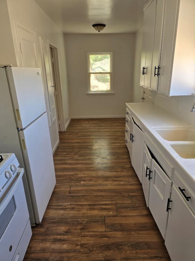 kitchen with dark hardwood / wood-style floors, white appliances, white cabinetry, and sink