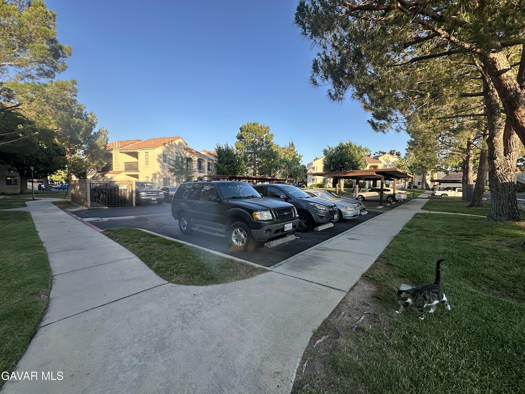 2554 Olive Dr Apt 12, Palmdale, CA 93550 - partially covered parking lot featuring a residential view