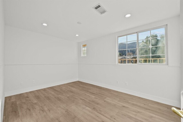 spare room with visible vents, recessed lighting, light wood finished floors, and baseboards