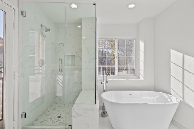 full bath featuring a freestanding tub, a marble finish shower, recessed lighting, and marble finish floor