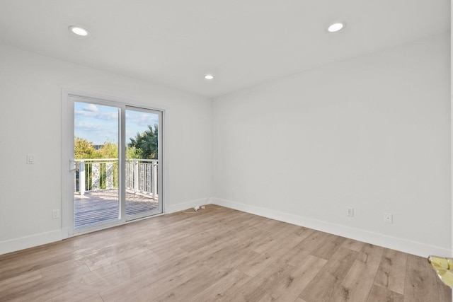 unfurnished room with baseboards, recessed lighting, and light wood-style flooring