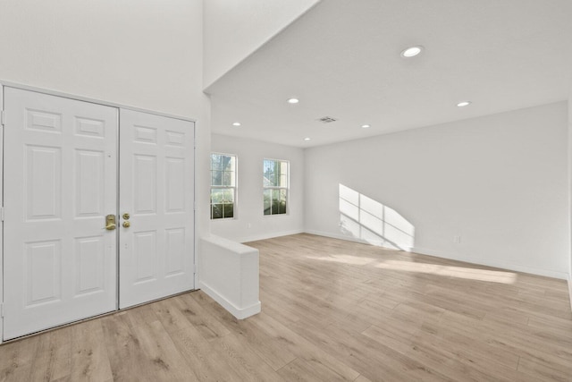 foyer entrance with light wood-style floors, baseboards, recessed lighting, and visible vents