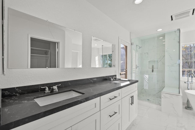 bathroom with visible vents, a sink, a marble finish shower, and marble finish floor