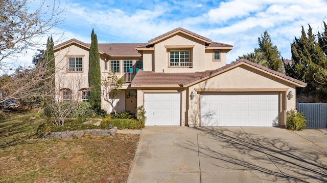 traditional-style house with fence, a garage, stucco siding, concrete driveway, and a tiled roof