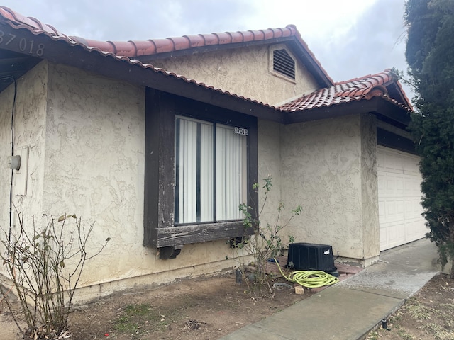 view of side of property with a garage