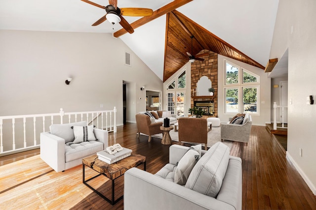 living room featuring high vaulted ceiling, a fireplace, hardwood / wood-style floors, and beam ceiling