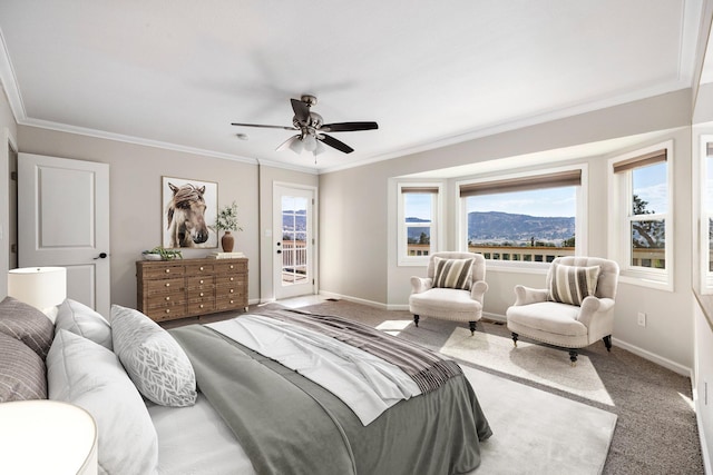 carpeted bedroom with ornamental molding, a mountain view, access to exterior, and ceiling fan