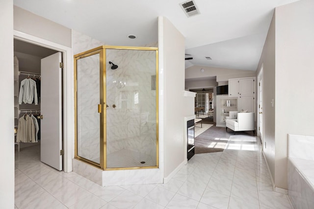 bathroom featuring tile patterned floors, lofted ceiling, separate shower and tub, and vanity