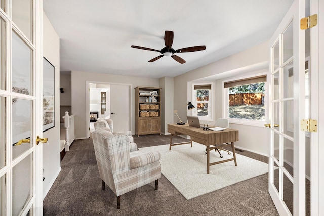 carpeted office space featuring french doors and ceiling fan