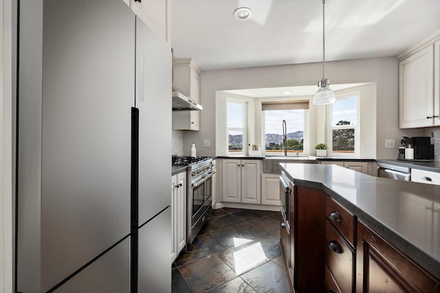 kitchen with white cabinetry, appliances with stainless steel finishes, sink, and hanging light fixtures