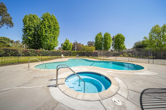 view of pool with fence, a fenced in pool, an in ground hot tub, and a patio