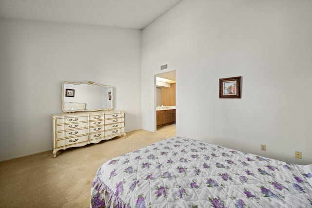 bedroom featuring a high ceiling, light carpet, and visible vents