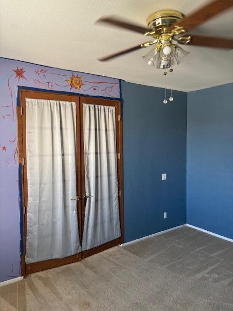 empty room with carpet and ceiling fan